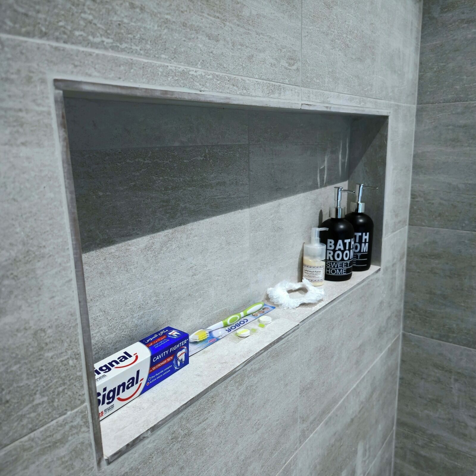 Ein Badezimmerschrank mit einer Zahnbürste, Zahnpasta und einer Handseifenflasche.