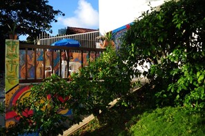 A colorful mural with abstract art and a blue umbrella. - Sopro de Iemanjá Hostal (Salvador)