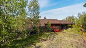 A rustic cabin with a wooden exterior, a chimney, and a red door. - Awesome home in Uvdal with sauna (Uvdal)