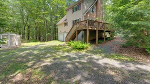 A two-story cabin with a wooden deck and a staircase leading to the upper level. - Game Room + Lake Access: Albrightsville Escape (Albrightsville)