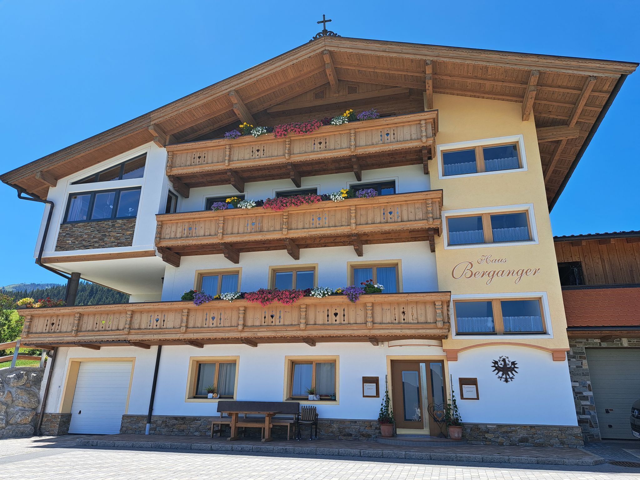 A multi-story hotel with wooden balconies, flower boxes, and a sign indicating it is a B&B.