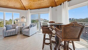 A spacious balcony with wicker furniture and a view of the surrounding landscape. - Tide Together | 880 ft to the beach (Corolla)