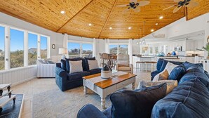 A spacious living area with a wooden ceiling, a dining area, and a kitchen. - Tide Together | 880 ft to the beach (Corolla)
