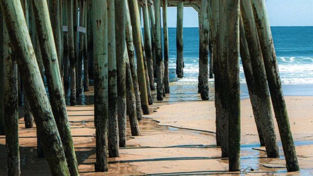 A wooden pier with a bar named 'Hurricane Raw Bar' at the end. - Walk to Beach & Pier | 1BR Suite with Pool & Kitchenette (Old Orchard Beach)