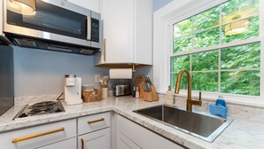 A modern kitchen with a built-in microwave, stove, and sink. - Heated Saltwater Pool  Short Walk to Beach Pier 9 (Old Orchard Beach)
