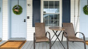 A porch with two chairs and a table, a door with a number, and two wreaths. - Heated Saltwater Pool  Short Walk to Beach Pier 10 (Old Orchard Beach)
