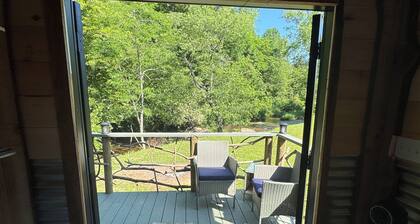 Tiny cabin sits by the bubbling, stocked creek.