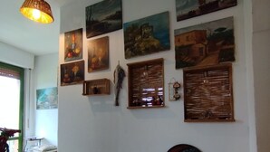 A hallway with a series of paintings and a mirror on the wall. - In the countryside, a cozy retreat for peaceful moments near Mount Vesuvius. (Torre del Greco)