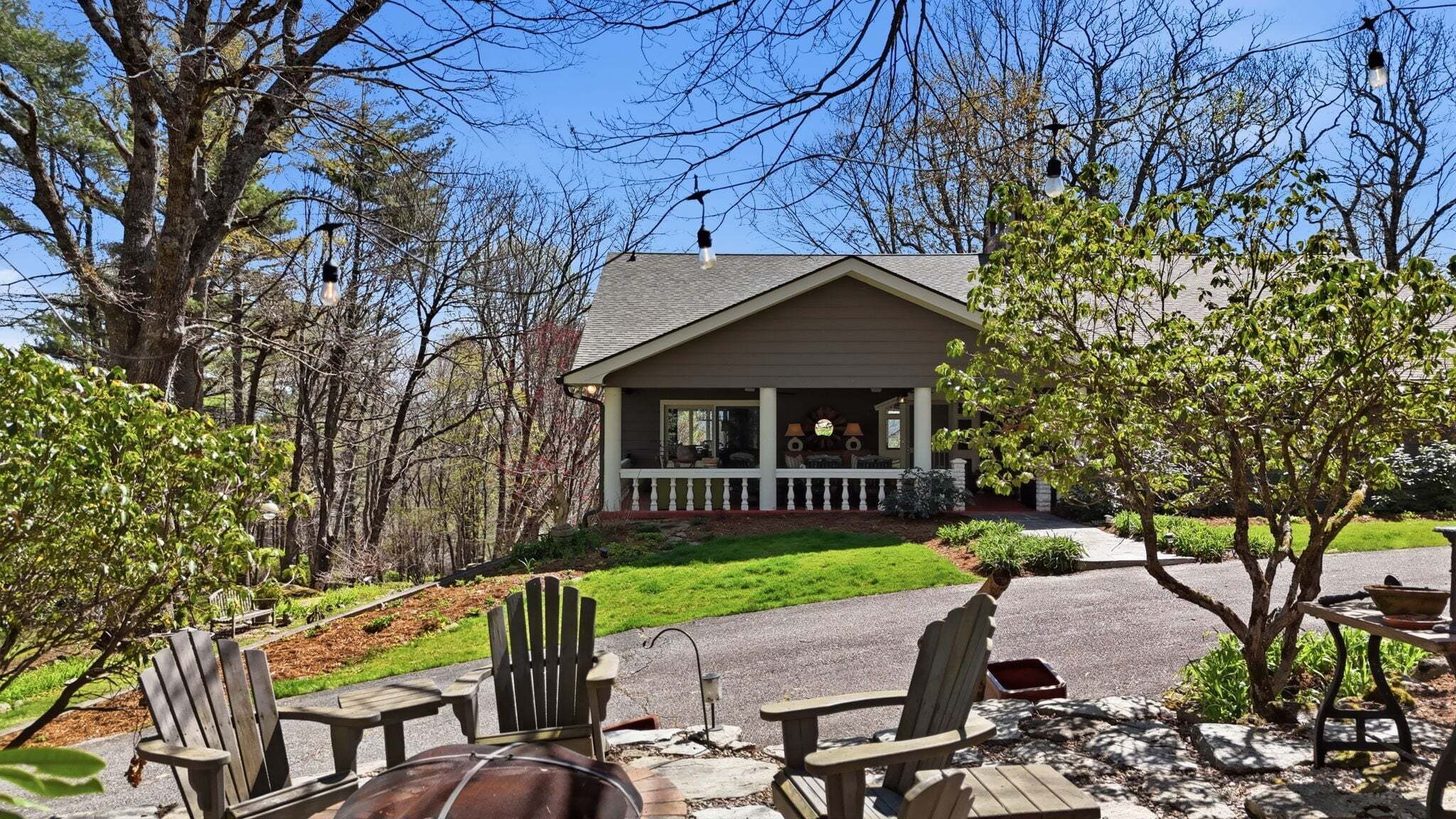 A lodge with a porch, outdoor seating, and a stone pathway.