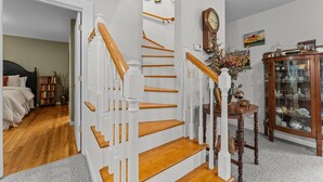A staircase with white balusters and wooden steps leading to a second floor.