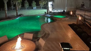 A nighttime outdoor area with a swimming pool, a fire pit, and outdoor seating. - Lake Blackshear Retreat! (Cordele)