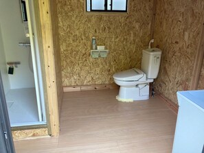A small, compact bathroom with a toilet, a small shelf with toiletries, and a window. - [Unexplored Area] Former private home with a beautiful river running through it. (京都市)