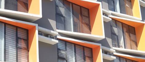 A modern building with multiple balconies and large windows.