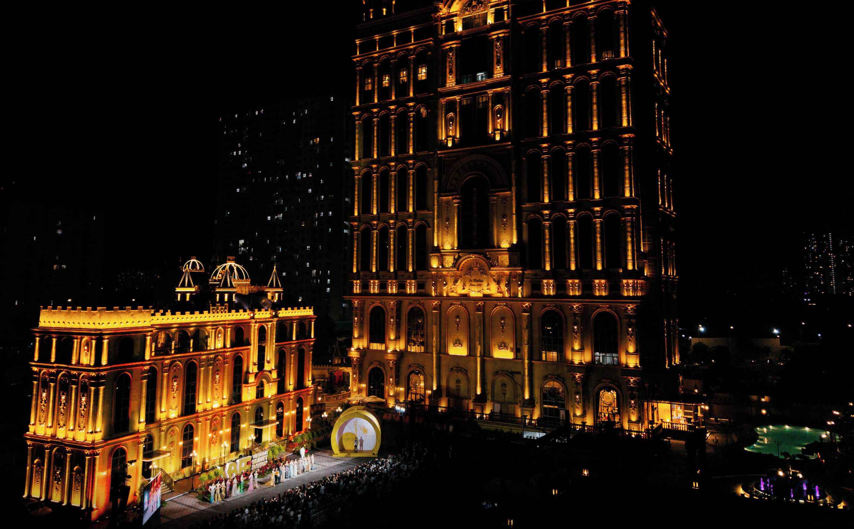 A historic building with ornate architecture and a large central dome, illuminated at night.