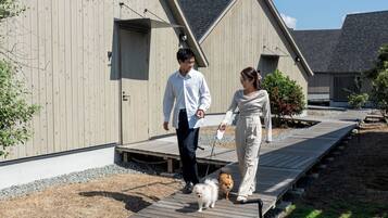 A wooden deck leading to a building with a sloped roof.