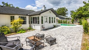 Une maison dotée d’un patio couvert, d’un espace salon extérieur et d’une piscine.