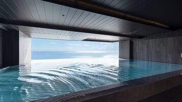 A modern infinity pool with a clear view of the ocean.