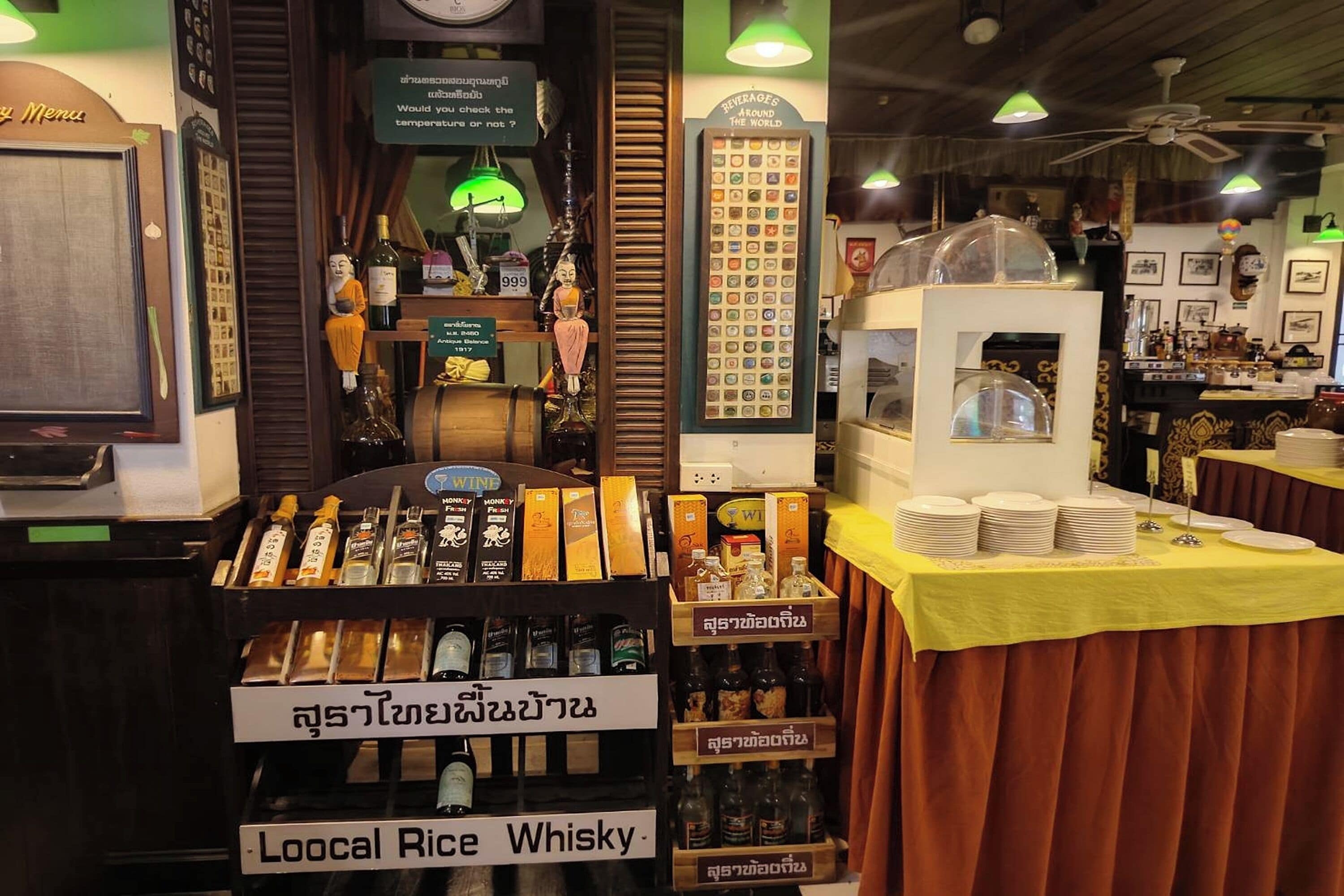 A bar area with a display of local rice whisky and various bottles.