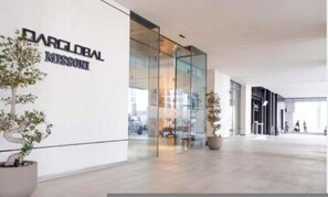 A modern building with a glass facade and a sign reading 'DARGLOBAL MISSION'.
