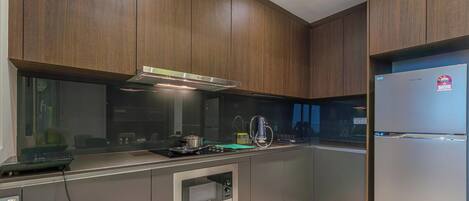 A modern kitchen with wooden cabinets, stainless steel appliances, and a built-in oven.