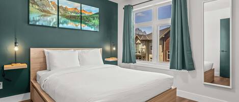 A modern bedroom with a wooden bed, a large window with curtains, and a view of a mountain house.