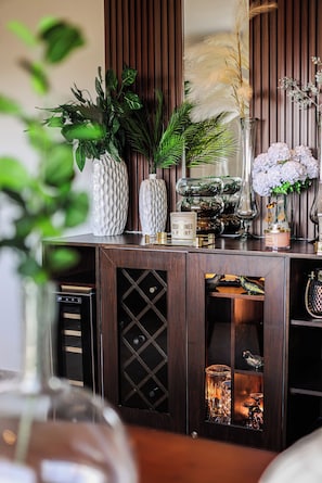 A wooden console with glass-fronted cabinets, decorative vases, and a mirror. - Palmares: Apt 3-Bedroom Retreat with Private Rooftop (Playa del Carmen)