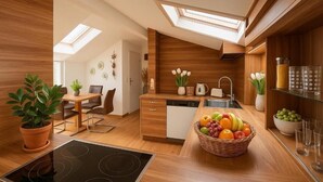 A modern kitchen with wooden cabinetry, a built-in oven, a dining area with a table and chairs, and a skylight above the kitchen.