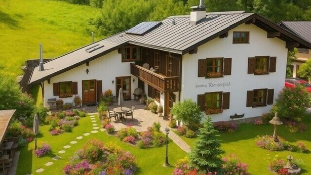 A white building with wooden shutters, a balcony, and a garden with stepping stones.