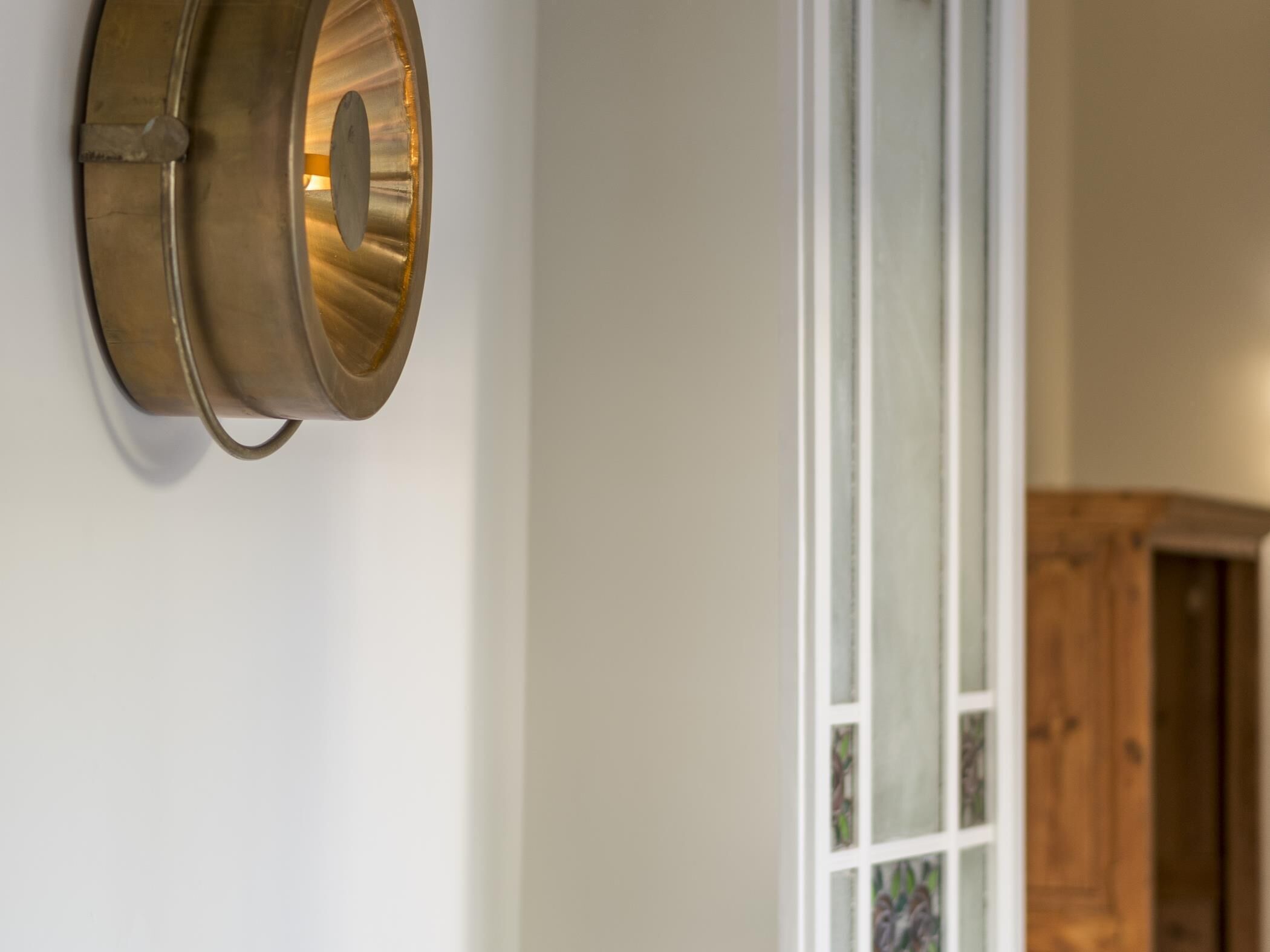 A wall-mounted light fixture with a metallic finish.