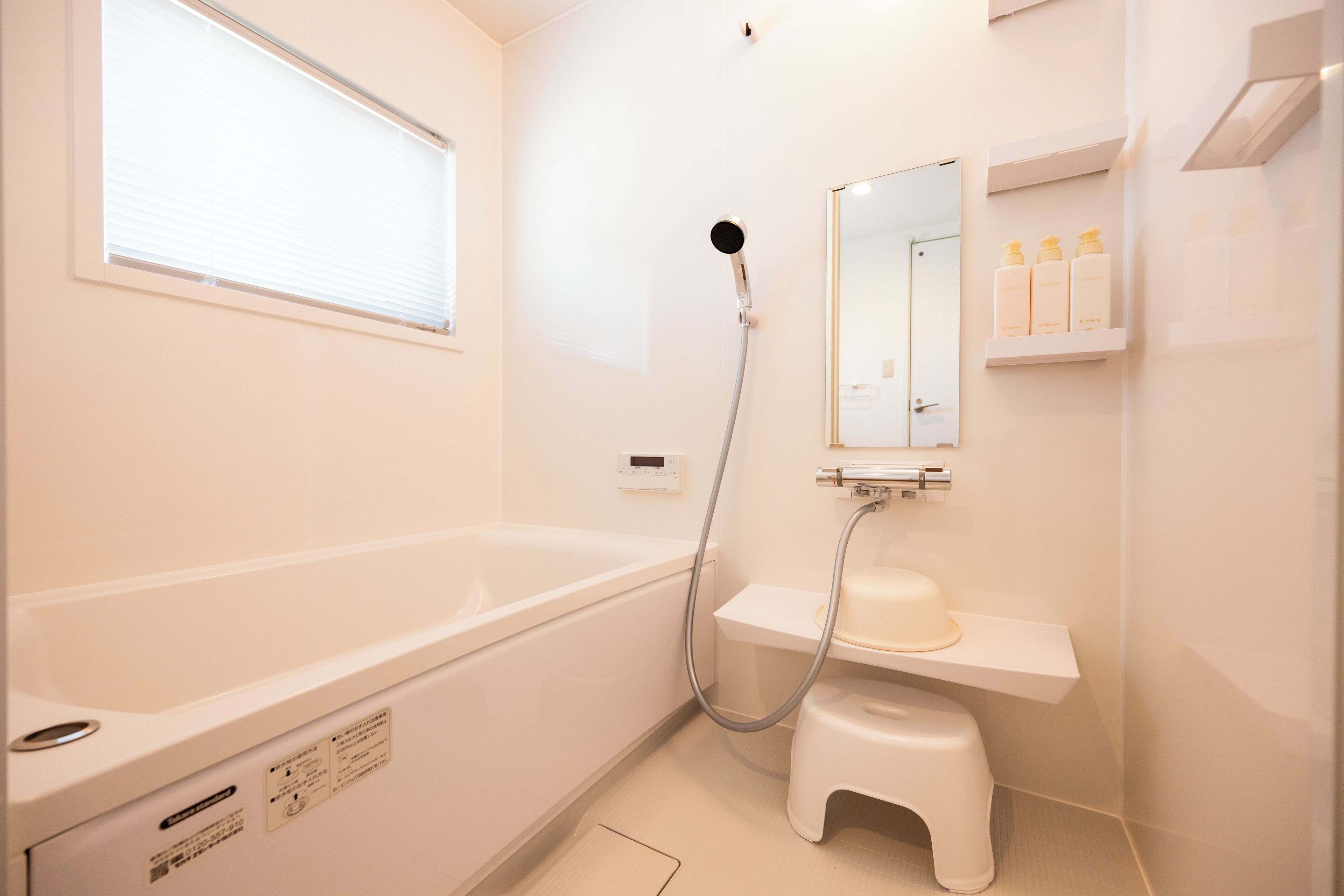 A modern bathroom with a bathtub, a shower, a toilet, and a sink.