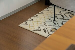 A patterned rug on a wooden floor.