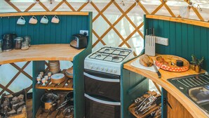 A compact kitchen with a gas stove, a toaster, and a sink. - Skylark Yurt - UKC6946 (Beaminster)