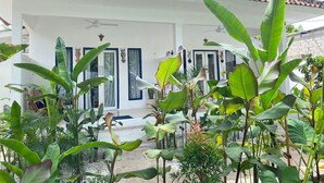 A white building with a tiled roof and large windows. - Lovys Gili Air (Gili Air)