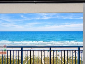 A balcony with a view of the ocean, beach, and a sign about recycling. - Vista Nuvia, Mins to Boardwalk (Myrtle Beach)