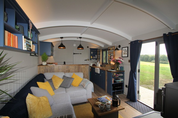 Open-plan living room and kitchen overlooking the fields