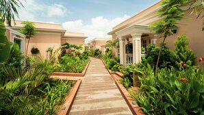 A pathway leading to a row of buildings with a garden in the middle. - Dolce Vita - Luxury Vacation Villas (Pushkar)