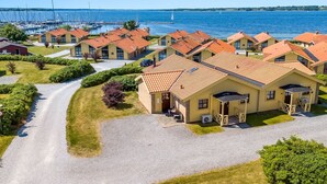A coastal residential area with houses featuring red-tiled roofs, a marina with boats, and a clear view of the sea. - "Era" - 100m from the sea by Interhome (Egernsund)