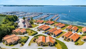 A marina with boats, a residential area with houses, and a clear blue sky. - "Era" - 100m from the sea by Interhome (Egernsund)