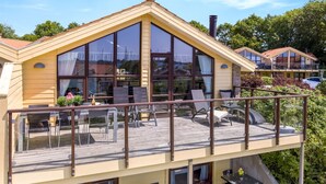 A two-story building with a balcony, large windows, and a chimney. - "Era" - 100m from the sea by Interhome (Egernsund)