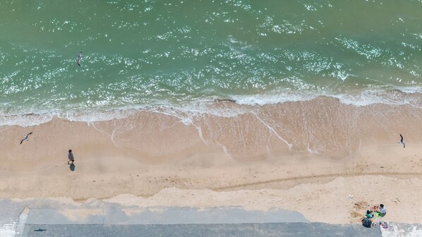 An aerial view of a beach with waves, sand, and people. - Boryeong The Daecheon Story Pension (Boryeong)