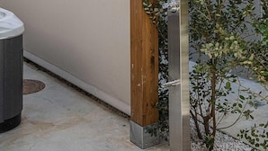 A modern outdoor entrance with a wooden frame and a metal door. - Lux Suite with Jacuzzi Near Beach (Chania)