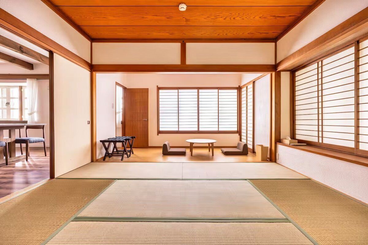 A traditional Japanese room with tatami flooring, sliding doors, and a shoji screen.