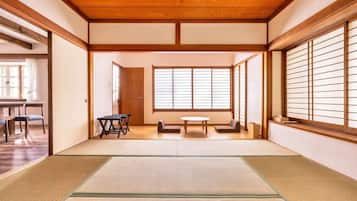 A traditional Japanese room with tatami flooring, sliding doors, and a shoji screen.
