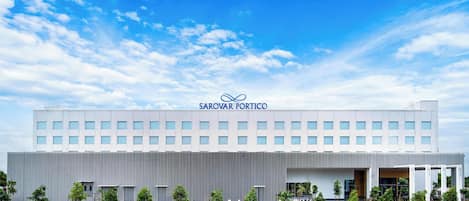 A modern building with a sign reading 'SAROVAR PORTICO.'