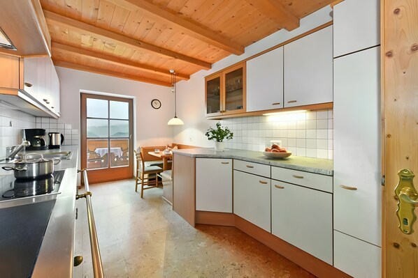 Fridge, stovetop, dishwasher, coffee/tea maker