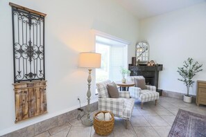 The guest house living room offers a peaceful, self-contained atmosphere—ideal for extended family or friends. Enjoy quiet mornings with coffee or unwind after a day in the sun in your own comfortable corner of the estate.