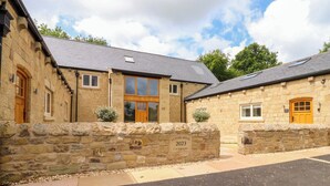 A stone building with a large wooden door and windows, labeled "Alston House 2023." - Heron View (Preston)