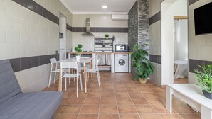 A compact living space with a kitchenette, a dining area, and a seating area.