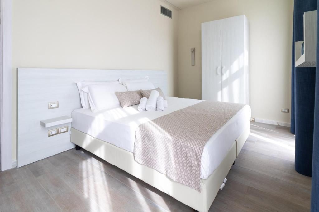 A bedroom with a bed, a wardrobe, and a bedside table.