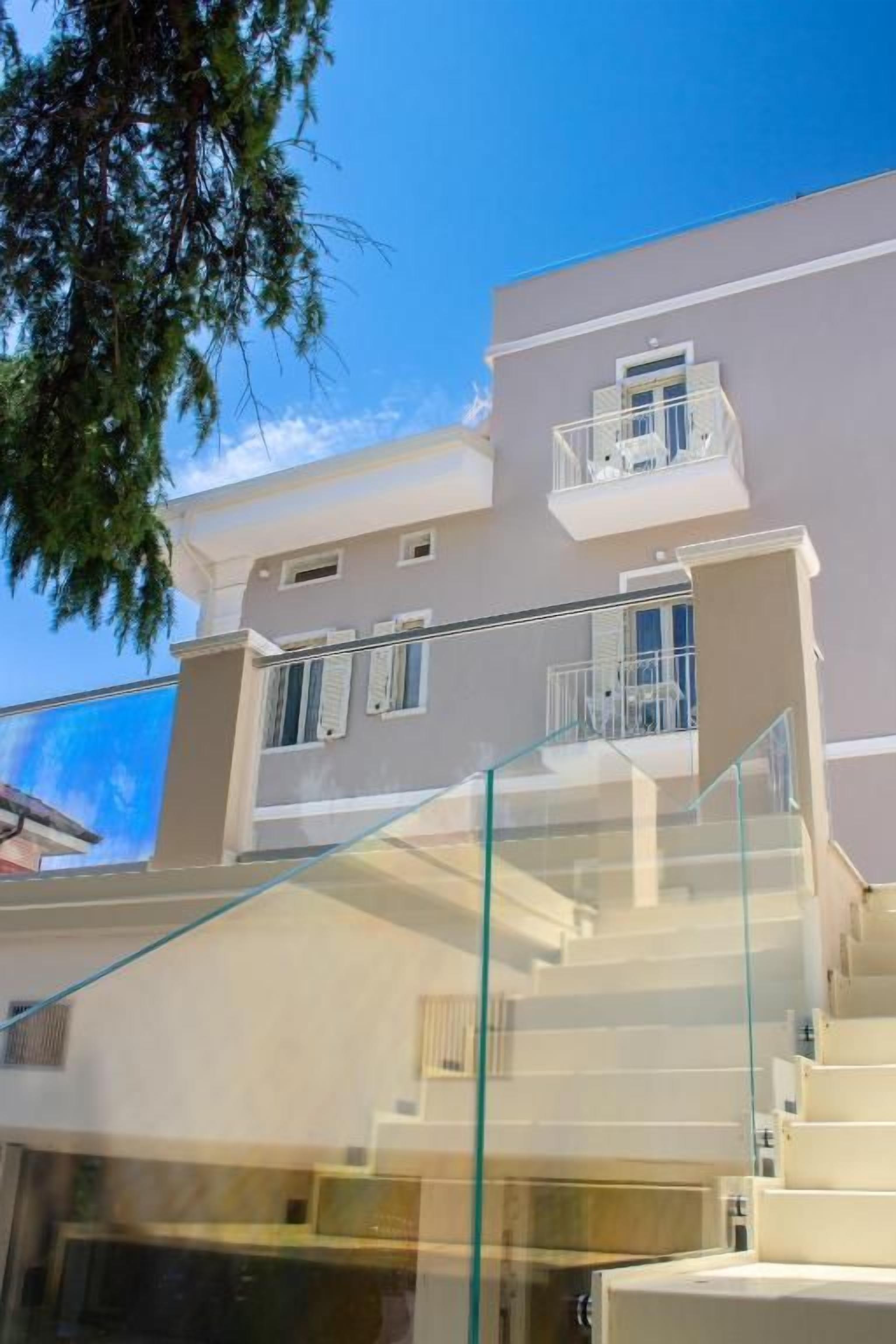 A multi-story building with a glass staircase and balconies.